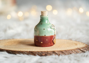 Jingle Bells in a bottle with gold accents